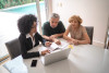 Real estate broker agent assisting couple with financial planning