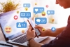Social media like and share icons floating over hands using laptop & smart phone
