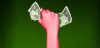a tightened fist gripping money