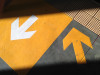 Yellow and white colored arrows drawn on pavement, AExperience, Road to Diversity