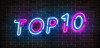 Top 10 neon blue and pink light text on empty red brick wall