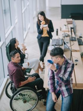 High angle view of diverse colleagues sharing a snack in office