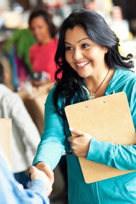 woman shaking hands during community event